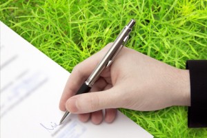 The Signature of Business Contract on the green Background