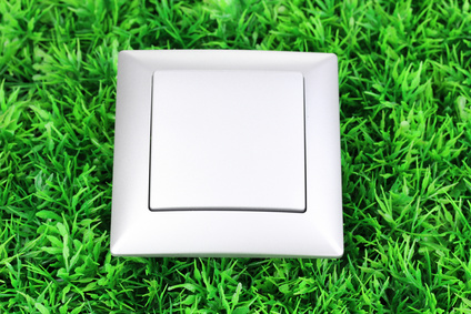 Modern light switch on green grass