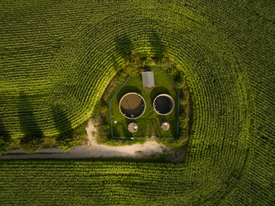 aerial view of small sewage treatment plant betwenn corn plants fields - top view