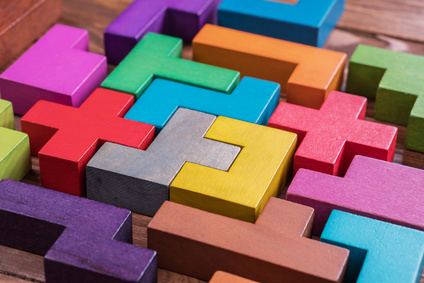 The concept of logical thinking. Geometric shapes on a wooden background.