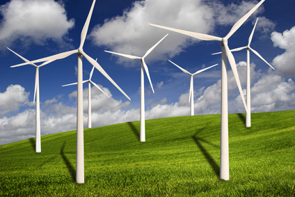 Beautiful green meadow with Wind turbines generating electricity