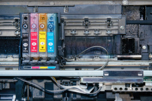 Old, dirty, disassembled inkjet printer. View of internal parts. Closeup.